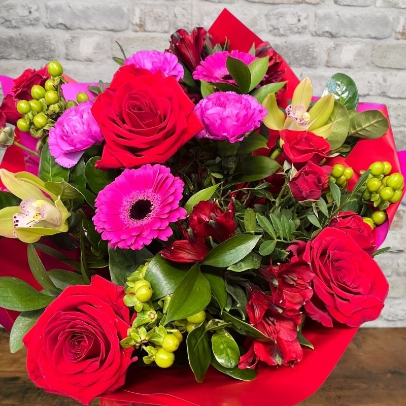 bold Valentine’s hand-tied bouquet with red and cerise flowers from West Malling Flowers