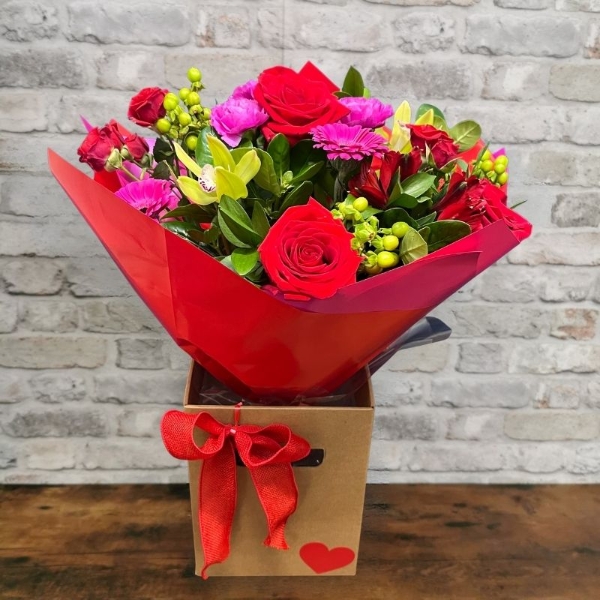 bold Valentine’s hand-tied bouquet with red and cerise flowers from West Malling Flowers