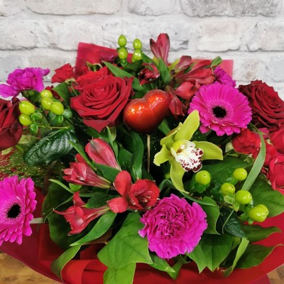 bold Valentine’s hand-tied bouquet with red and cerise flowers from West Malling Flowers