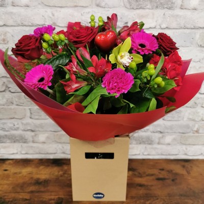 bold Valentine’s hand-tied bouquet with red and cerise flowers from West Malling Flowers