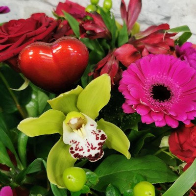 bold Valentine’s hand-tied bouquet with red and cerise flowers from West Malling Flowers