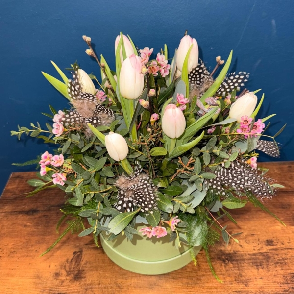 Spring hat box flower arrangement with pink and white seasonal flowers