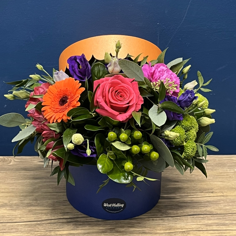 bright blue and orange hat box flower arrangement West Malling Flowers