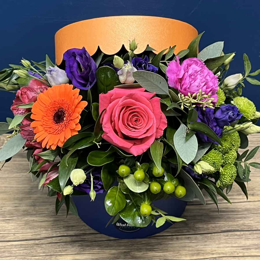 bright blue and orange hat box flower arrangement West Malling Flowers