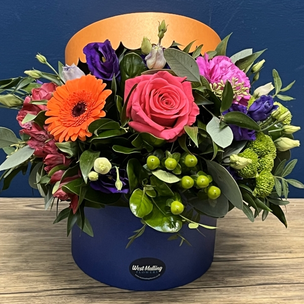 bright blue and orange hat box flower arrangement West Malling Flowers