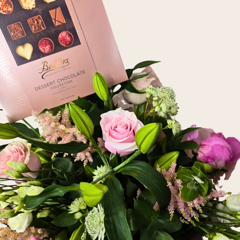 Luxury hand-tied bouquet featuring pink peonies, lilies, roses and seasonal flowers in soft pink, blush and ivory tones.