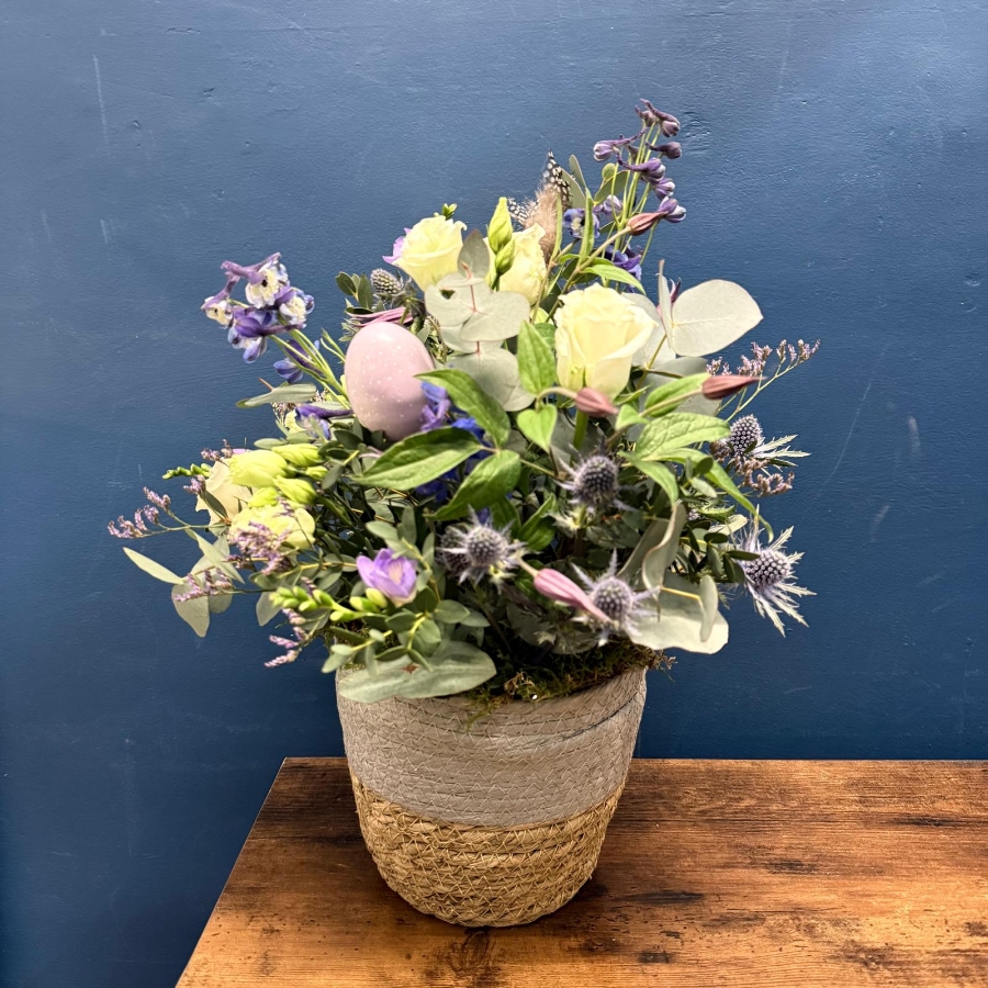 Spring flower basket arrangement with pink white and lilac seasonal flowers