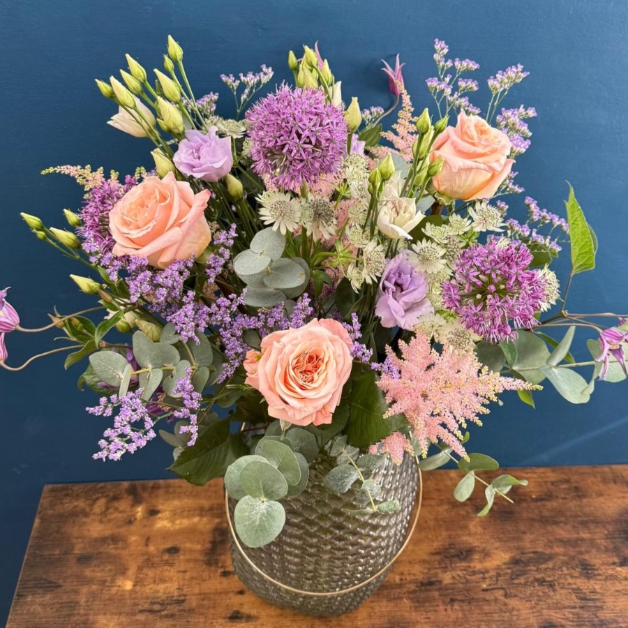 Pastel flower arrangement in glass lantern vase with gold frame tealight holder