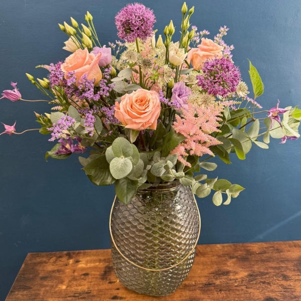 Pastel flower arrangement in glass lantern vase with gold frame tealight holder