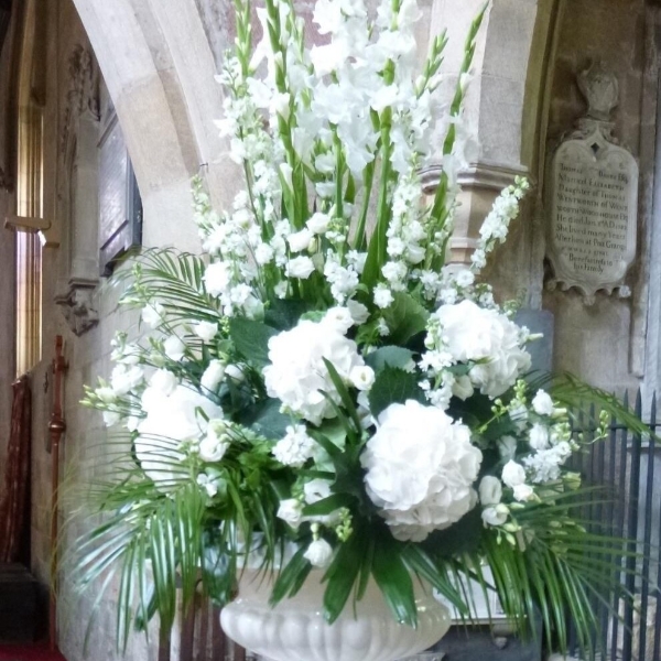 Large white pedestal flower arrangement for wedding ceremony