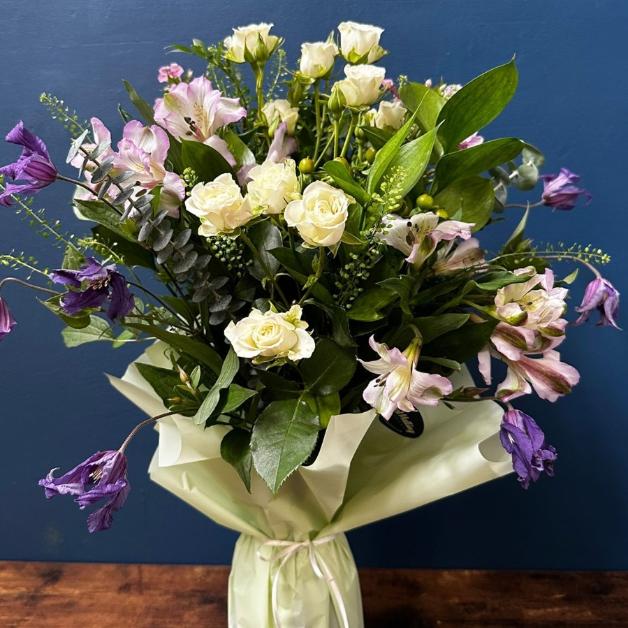 Sympathy flowers in gift wrapped vase with white and pastel seasonal flowers