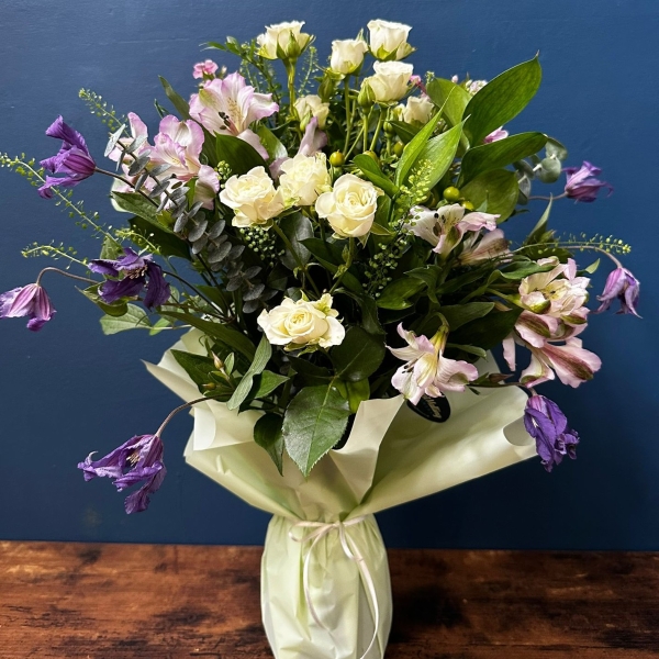 Sympathy flowers in gift wrapped vase with white and pastel seasonal flowers