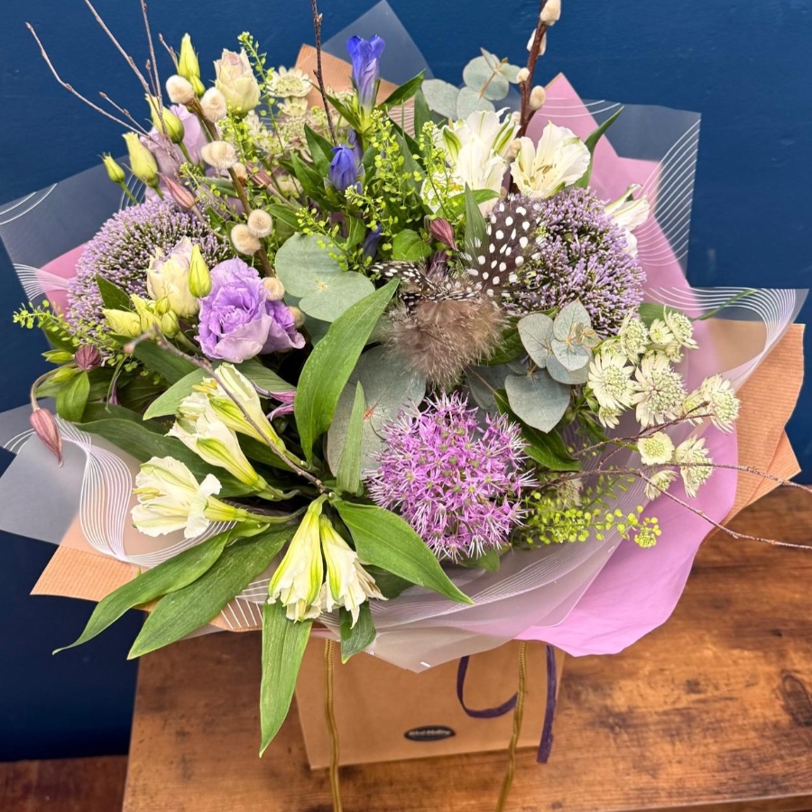 Pastel spring hand tied bouquet with pink white and lilac seasonal flowers