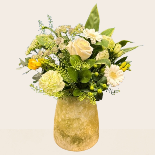 Yellow and white summer flower arrangement in decorative lemon vase