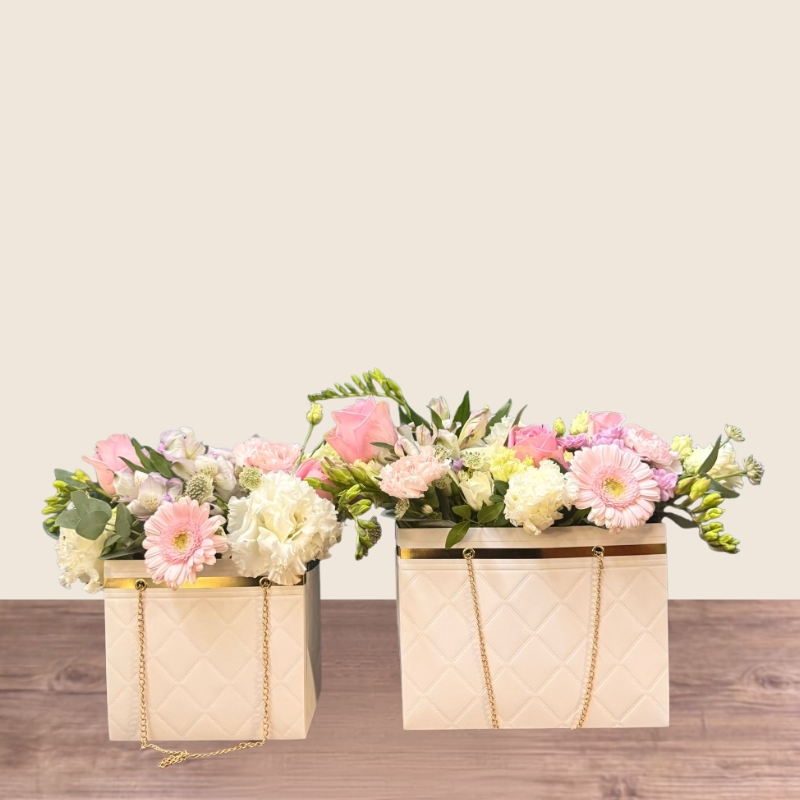 Mother’s Day flower arrangement in a white handbag gift container with soft pastel blooms, Paris collection West Malling florist