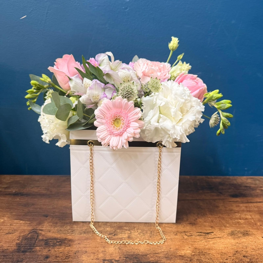 Mother’s Day flower arrangement in a white handbag gift container with soft pastel blooms, Paris collection West Malling florist