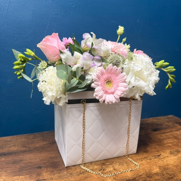 Mother’s Day flower arrangement in a white handbag gift container with soft pastel blooms, Paris collection West Malling florist