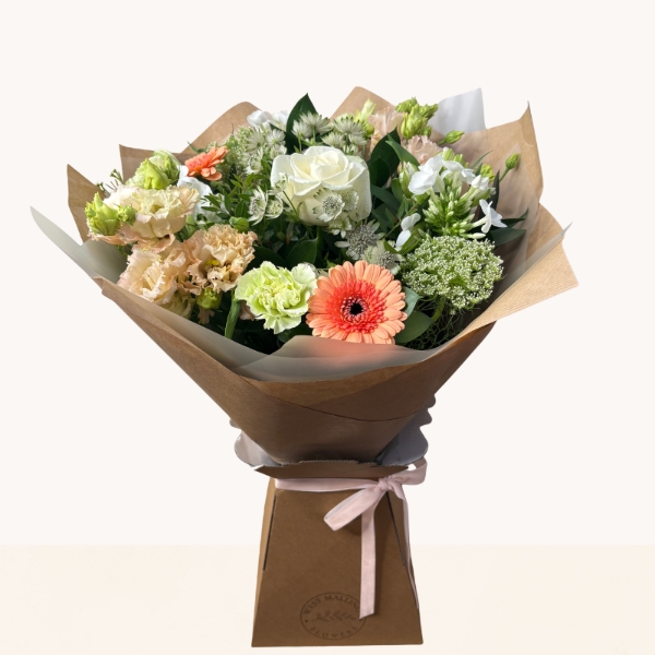 Late summer hand-tied bouquet with peach, cream and white seasonal flowers, fresh greenery and gift box.