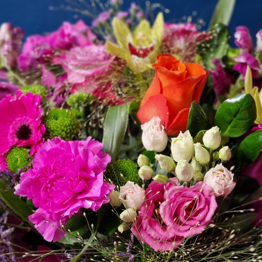 Bright summer hand tied bouquet with cerise purple orange and lime seasonal flowers