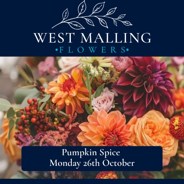 Autumn pumpkin arrangement filled with burgundy, orange and pink flowers, succulents and seasonal foliage created during a West Malling Flowers workshop.