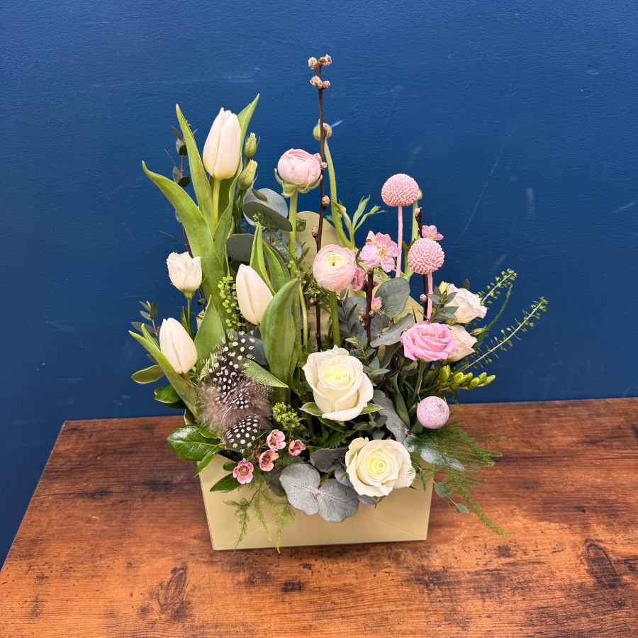 Spring envelope flower arrangement with pink and white seasonal flowers