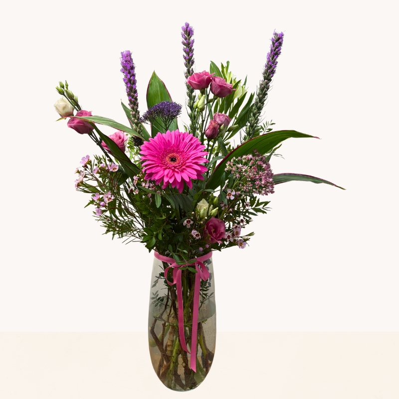 Summer Splash glass vase arrangement with vibrant pink and purple seasonal flowers by West Malling Flowers