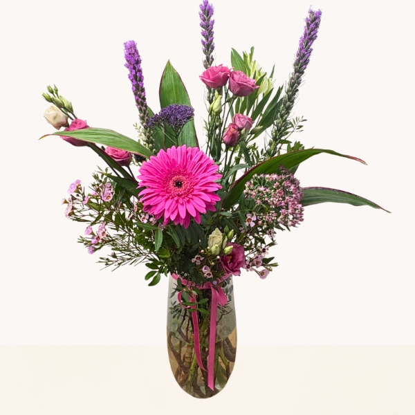 Summer Splash glass vase arrangement with vibrant pink and purple seasonal flowers by West Malling Flowers