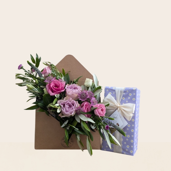 Pastel summer flower arrangement in kraft envelope with pink and lilac seasonal flowers
