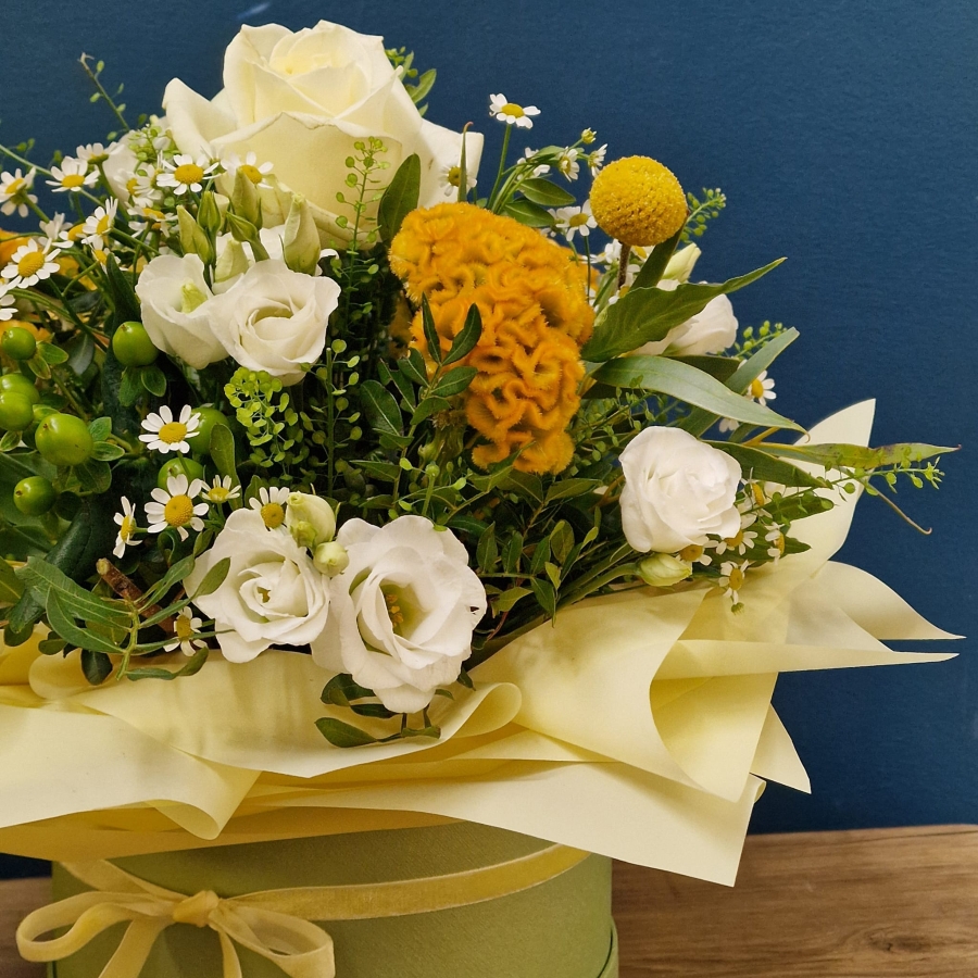 Citrus summer hat box arrangement with yellow and white seasonal flowers and unique wrapped design
