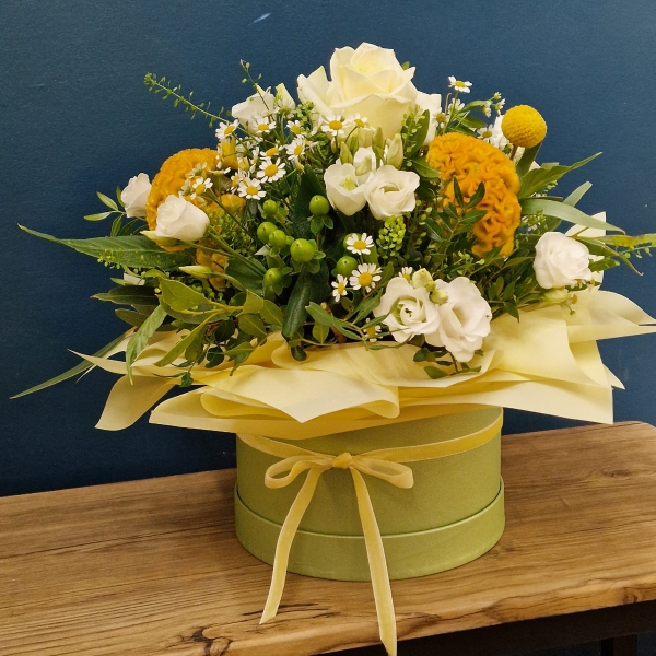 Citrus summer hat box arrangement with yellow and white seasonal flowers and unique wrapped design