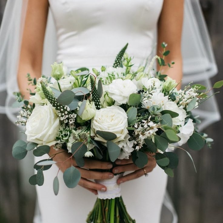 Classic white bridal bouquet with ivory flowers and soft greenery