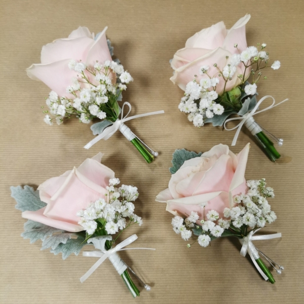 Pastel wedding buttonhole with seasonal flowers and natural foliage