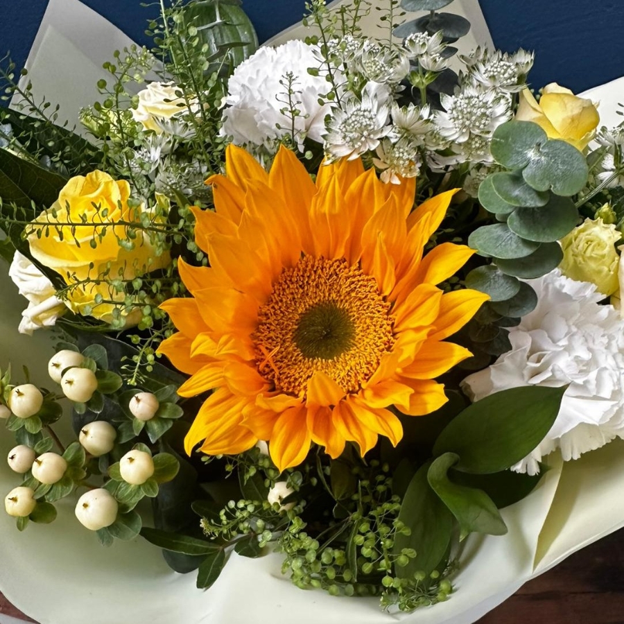 White and yellow sympathy hand tied bouquet with seasonal flowers and soft foliage