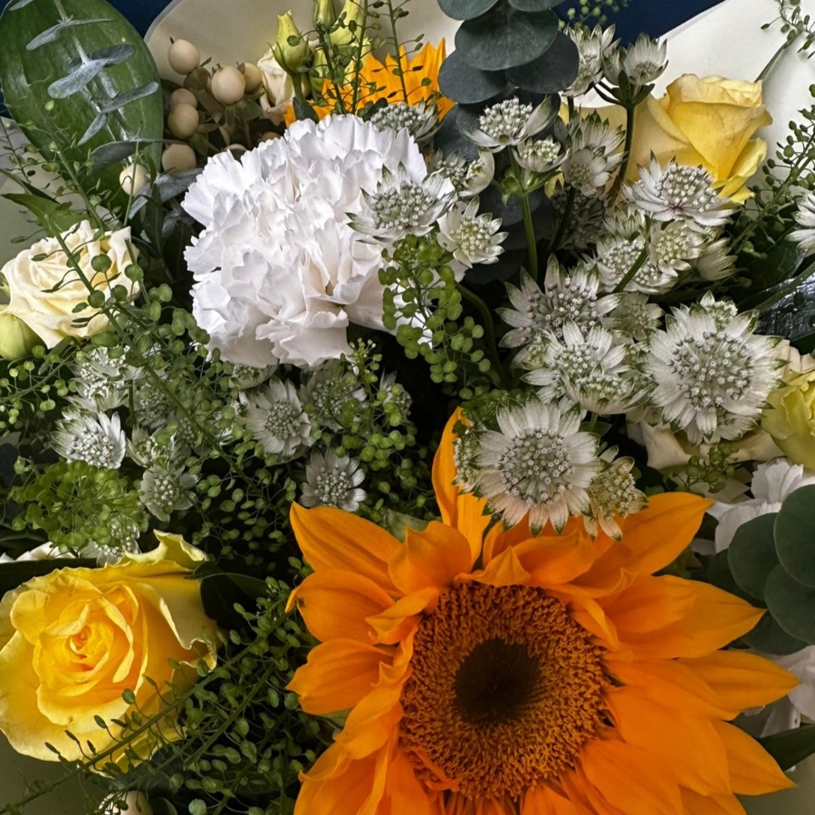 White and yellow sympathy hand tied bouquet with seasonal flowers and soft foliage