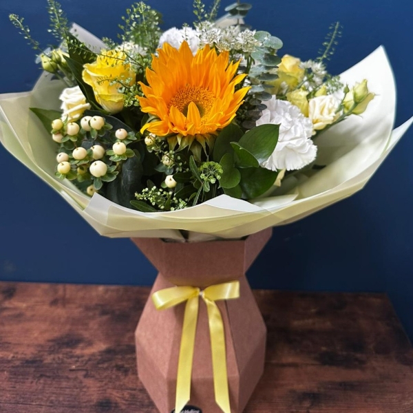 White and yellow sympathy hand tied bouquet with seasonal flowers and soft foliage