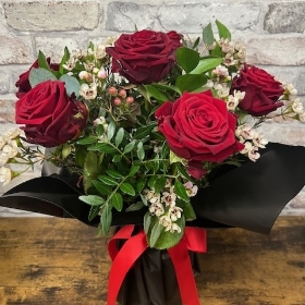 six red roses arranged in a vase by West Malling Flowers