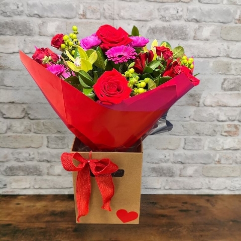 bold Valentine’s hand-tied bouquet with red and cerise flowers from West Malling Flowers