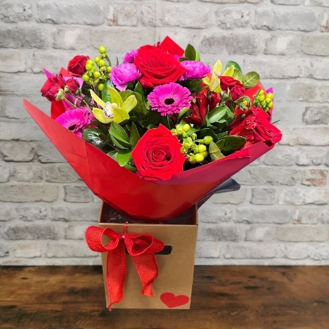 bold Valentine’s hand-tied bouquet with red and cerise flowers from West Malling Flowers