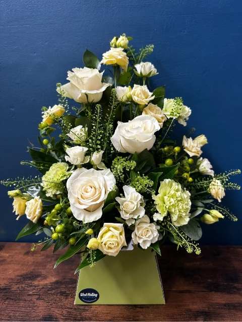 White sympathy flower box arrangement with front facing seasonal white flowers