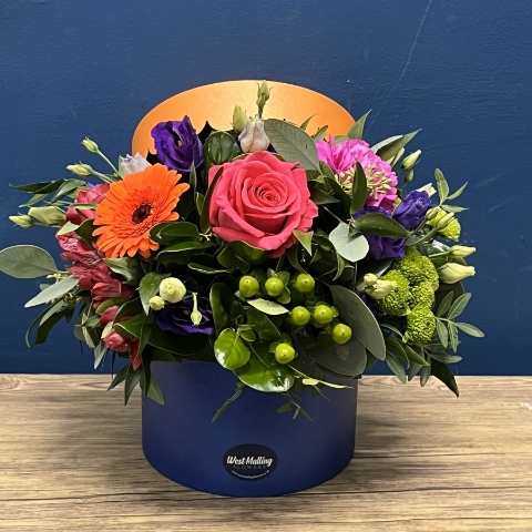 bright blue and orange hat box flower arrangement West Malling Flowers