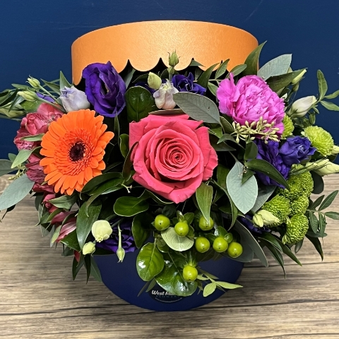 bright blue and orange hat box flower arrangement West Malling Flowers