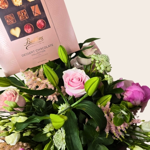 Luxury hand-tied bouquet featuring pink peonies, lilies, roses and seasonal flowers in soft pink, blush and ivory tones.