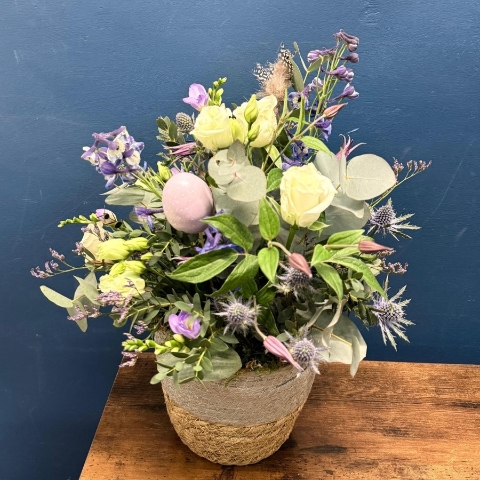 Spring flower basket arrangement with pink white and lilac seasonal flowers