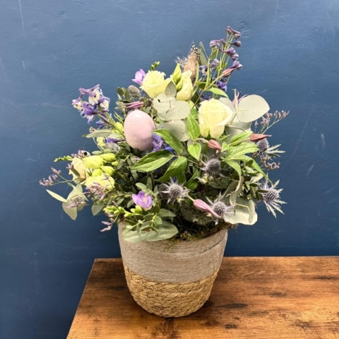 Spring flower basket arrangement with pink white and lilac seasonal flowers