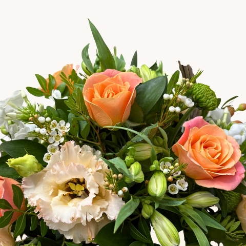 Summer Glow basket arrangement with peach, cream, white and green seasonal flowers by West Malling Flowers