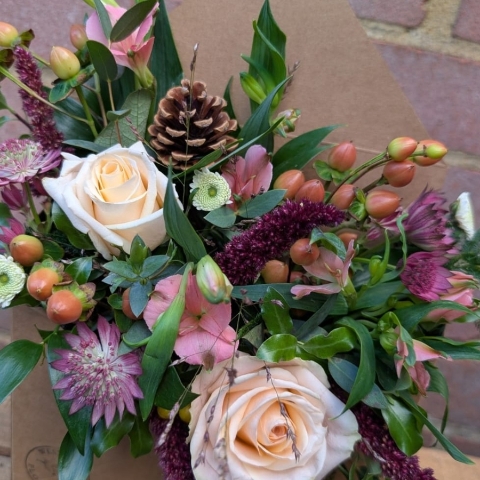 Autumn Haze kraft envelope arrangement with peach, blush, bronze and burgundy seasonal flowers