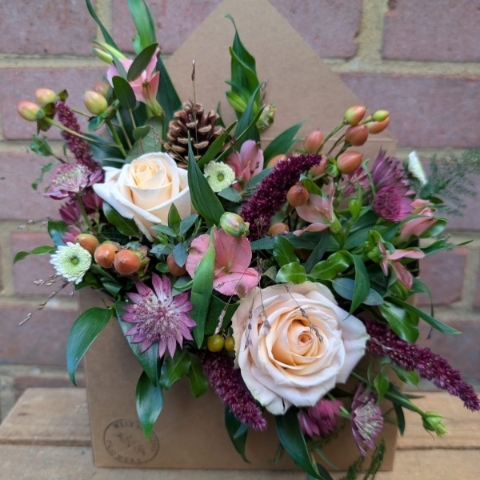 Autumn Haze kraft envelope arrangement with peach, blush, bronze and burgundy seasonal flowers