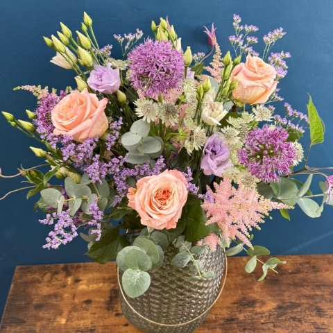 Pastel flower arrangement in glass lantern vase with gold frame tealight holder