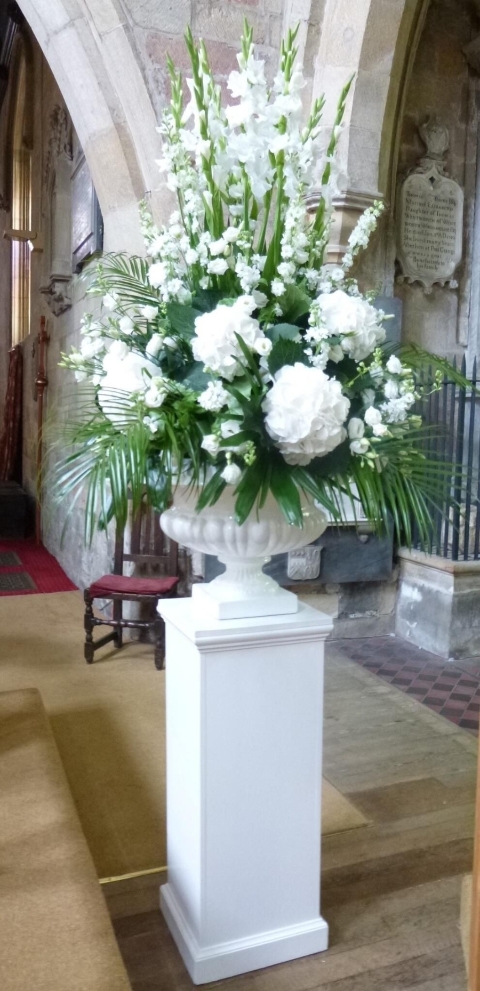 Large white pedestal flower arrangement for wedding ceremony