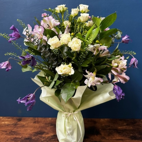 Sympathy flowers in gift wrapped vase with white and pastel seasonal flowers